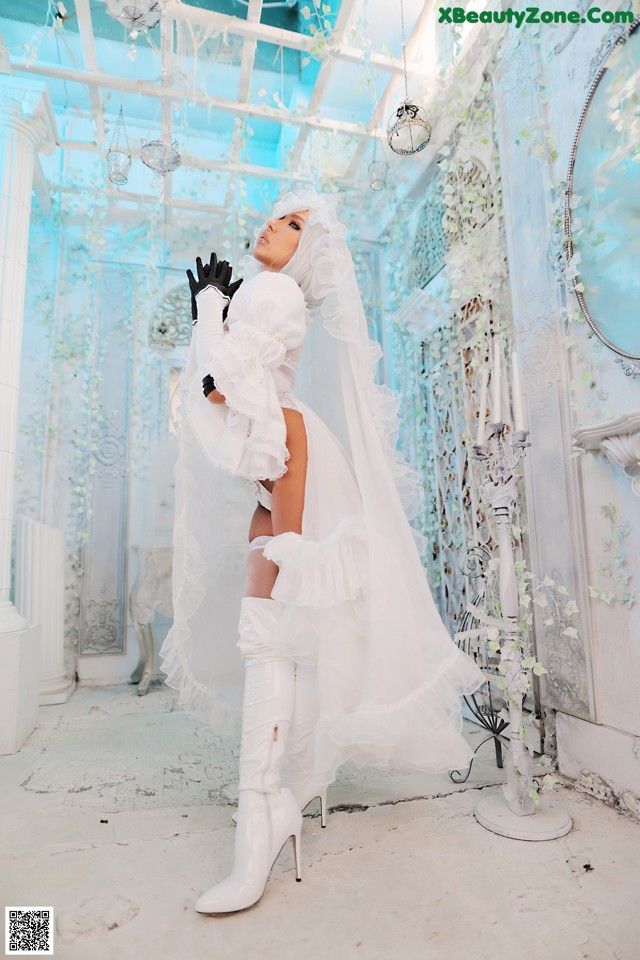 A woman in a wedding dress and boots posing for a picture.