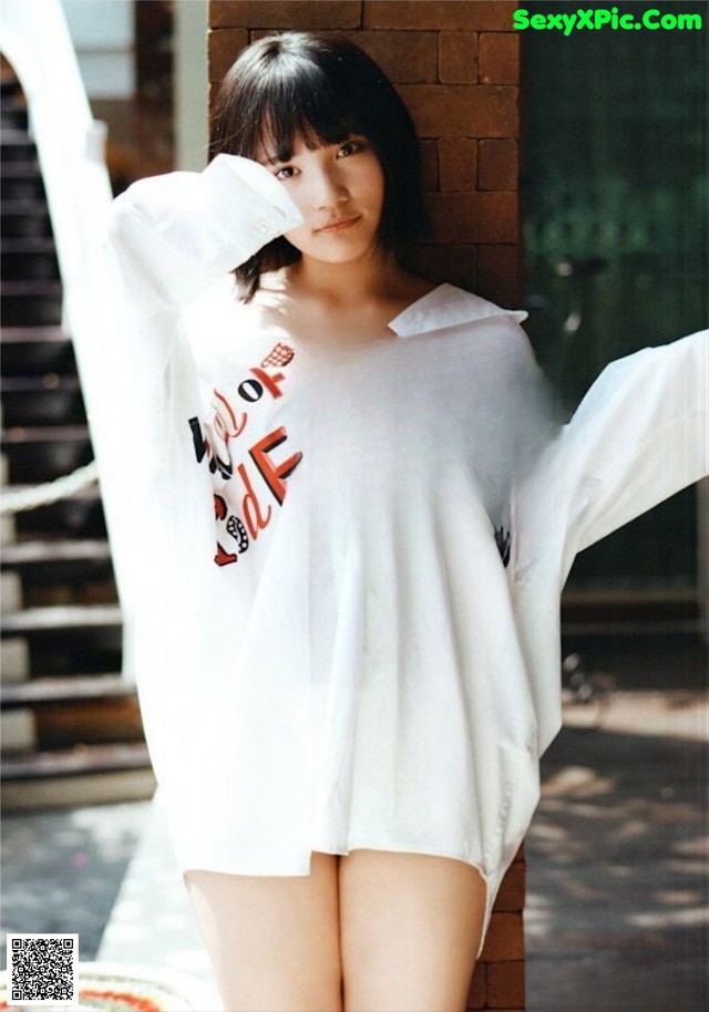 A woman in a white shirt is posing for a picture.